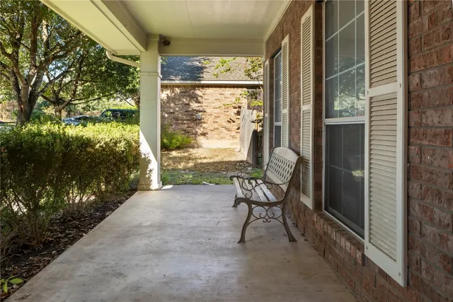 a view of a porch with chairs and a yard