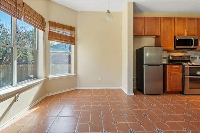 a view of a kitchen with a sink and a refrigerator