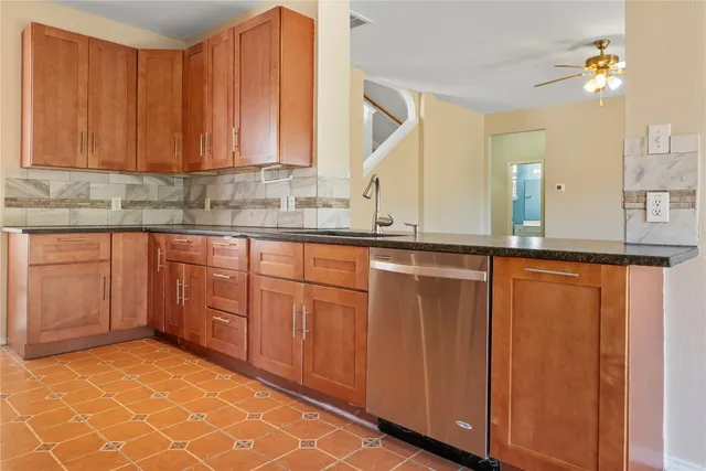 a kitchen with stainless steel appliances granite countertop a sink and cabinets