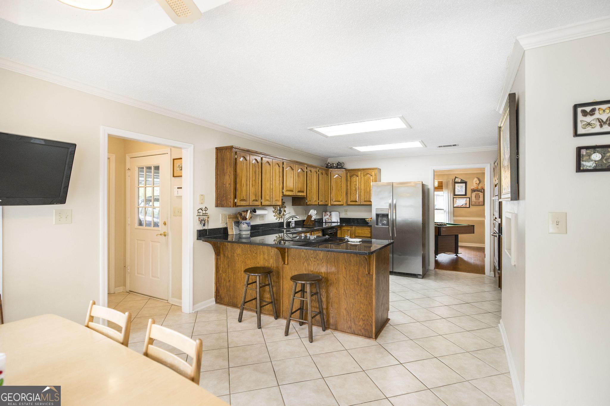 108 Bunkers Trail Warner Robins, GA 31088 - Photo 13 of 34 a kitchen with stainless steel appliances kitchen island granite countertop a sink and cabinets