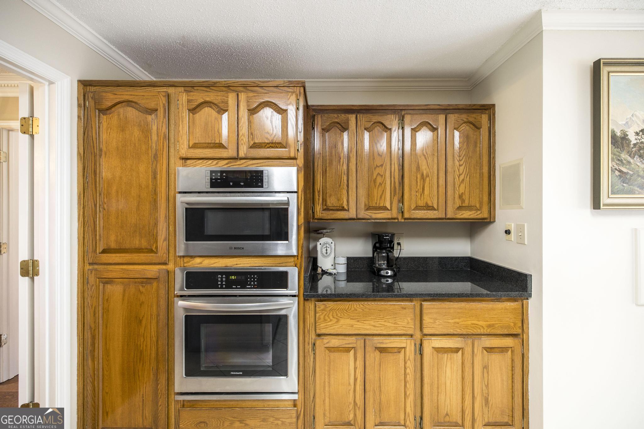 108 Bunkers Trail Warner Robins, GA 31088 - Photo 16 of 34 a kitchen with granite countertop cabinets stainless steel appliances and a window