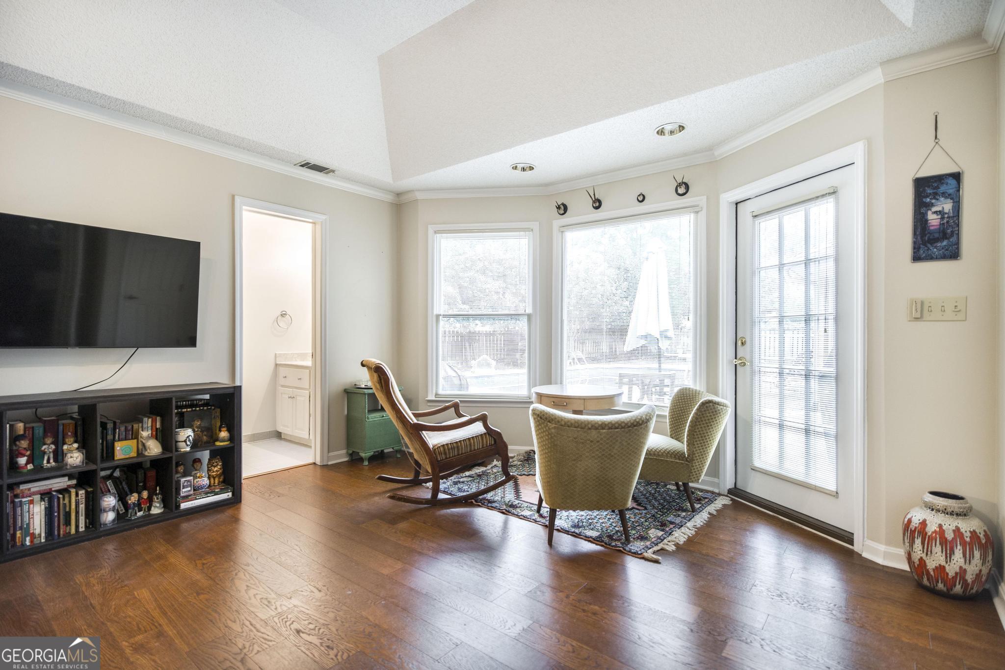 108 Bunkers Trail Warner Robins, GA 31088 - Photo 21 of 34 a living room with furniture and a flat screen tv with wooden floor