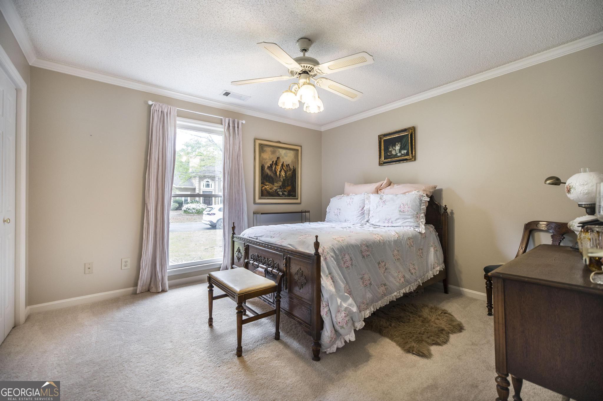 108 Bunkers Trail Warner Robins, GA 31088 - Photo 26 of 34 a bedroom with a bed and a chandelier