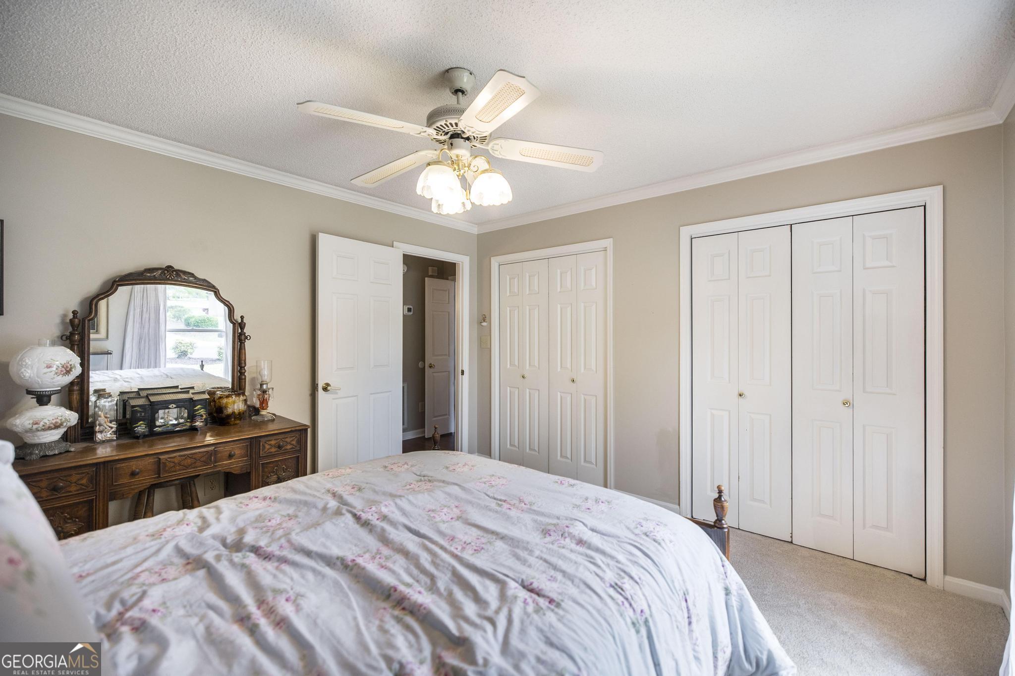 108 Bunkers Trail Warner Robins, GA 31088 - Photo 27 of 34 a bedroom with a bed and a chandelier