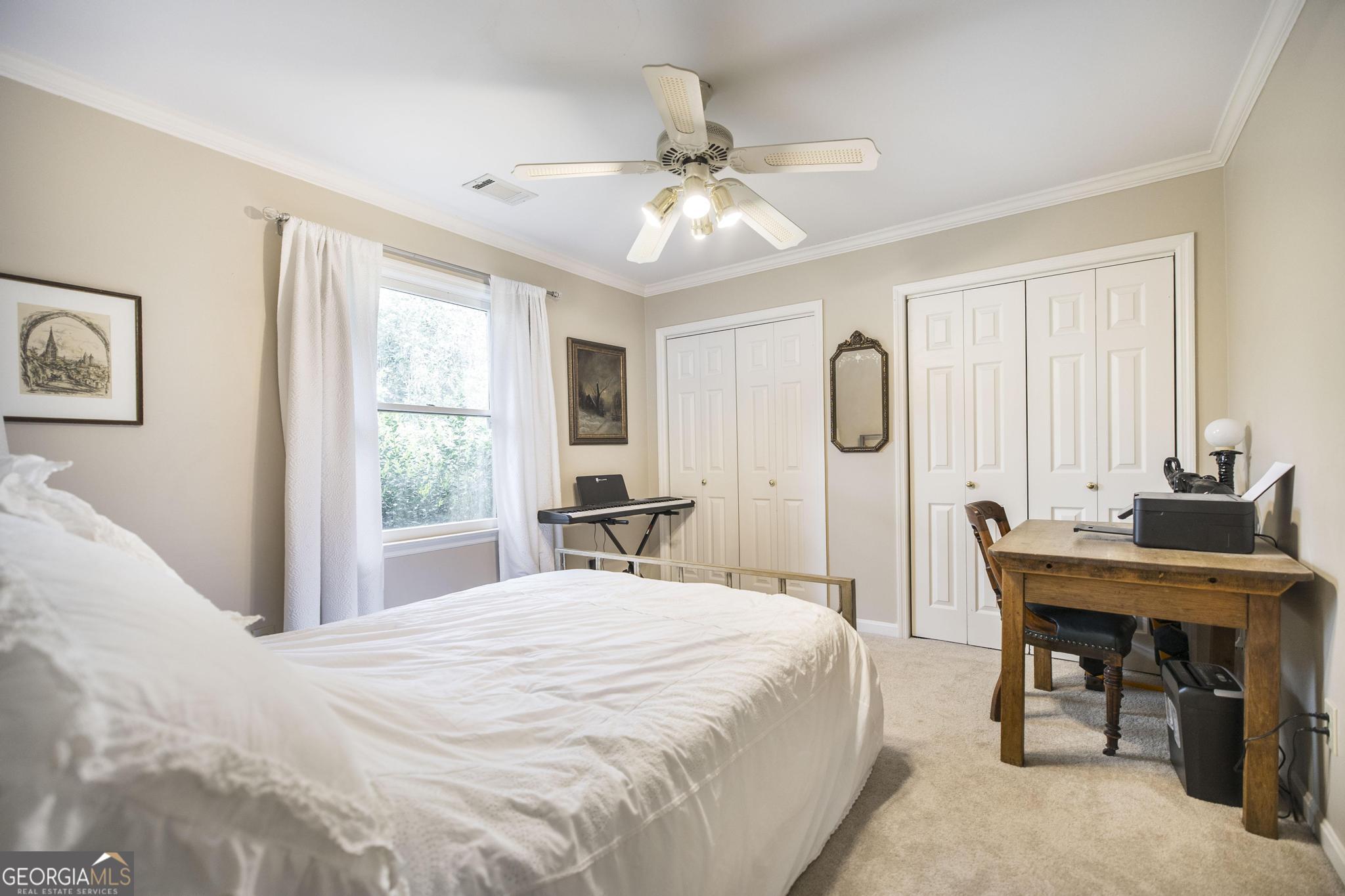 108 Bunkers Trail Warner Robins, GA 31088 - Photo 29 of 34 a bedroom with a bed and a table in it with window
