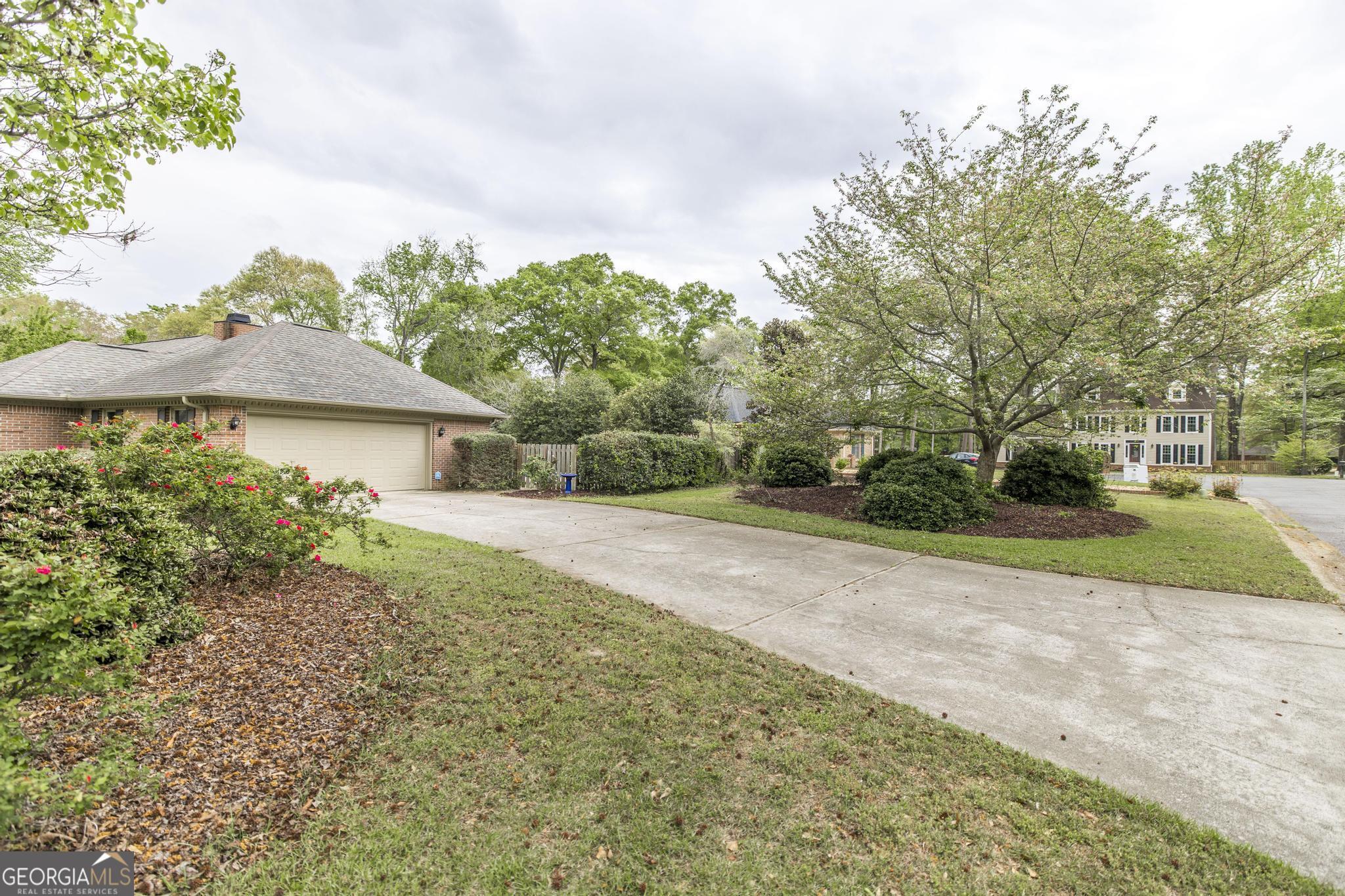 108 Bunkers Trail Warner Robins, GA 31088 - Photo 4 of 34 a front view of a house with a yard and garage