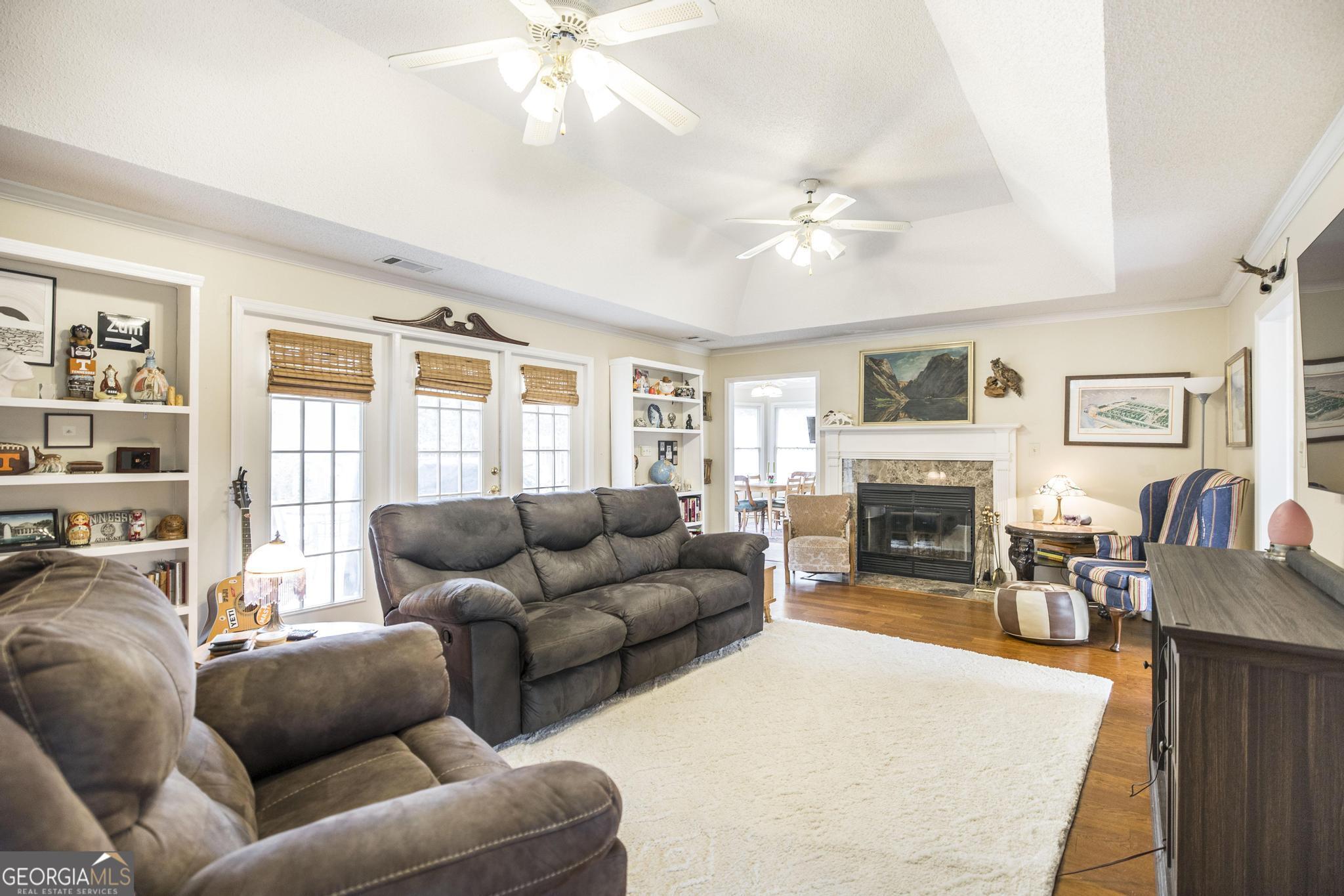 108 Bunkers Trail Warner Robins, GA 31088 - Photo 9 of 34 a living room with furniture a fireplace and a flat screen tv