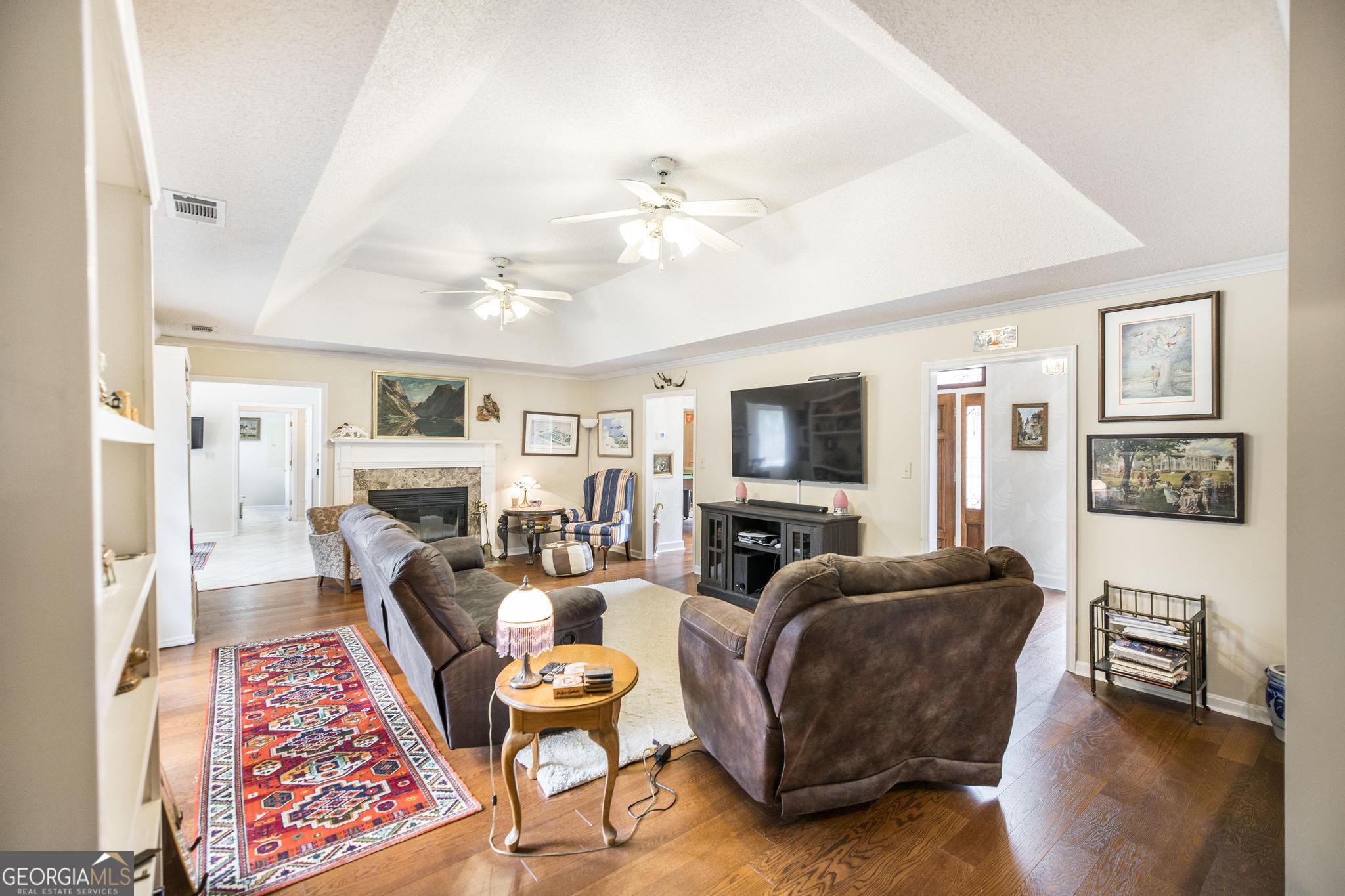 108 Bunkers Trail Warner Robins, GA 31088 - Photo 10 of 34 a living room with furniture fireplace and a flat screen tv