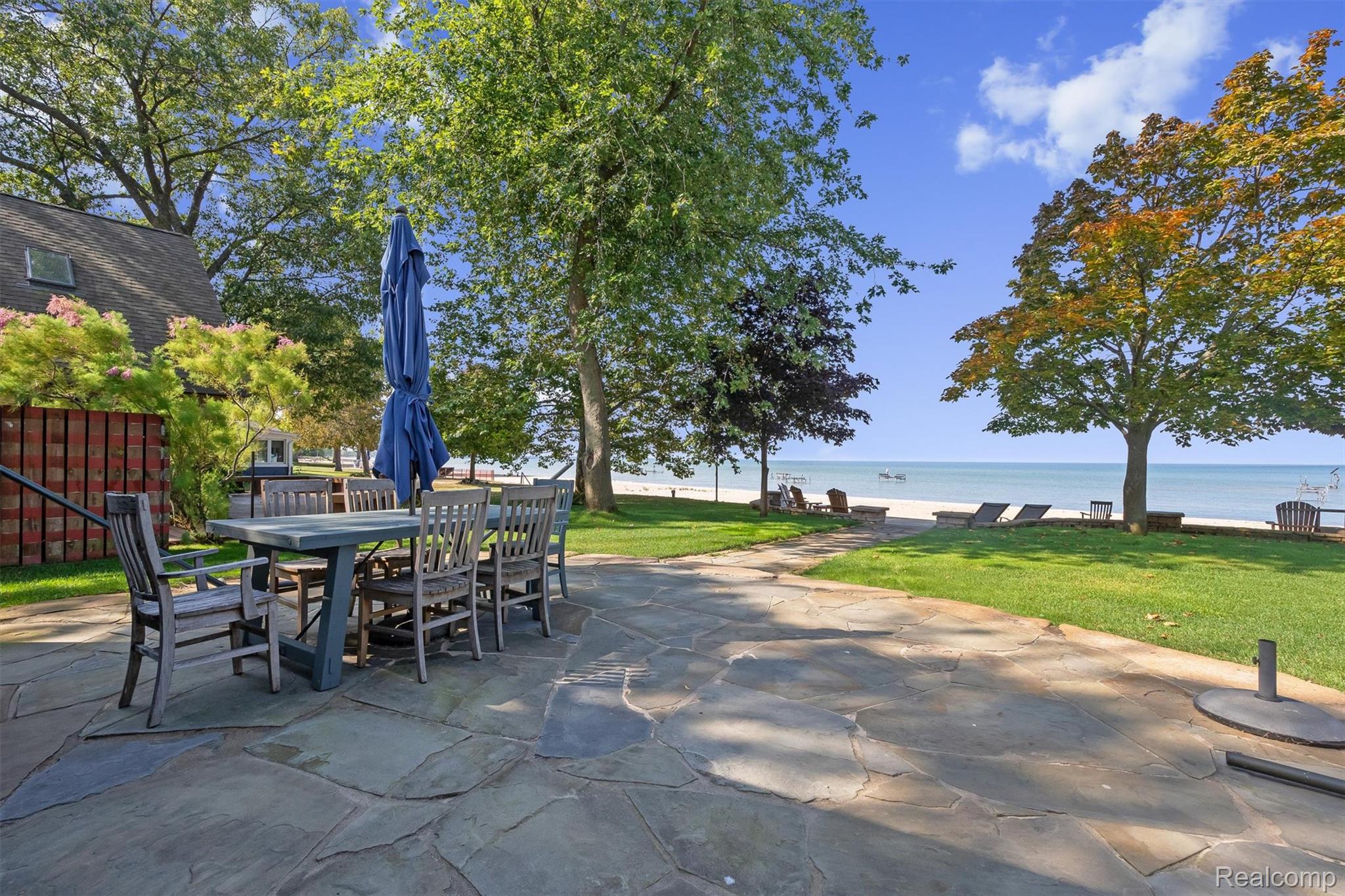 5892 Port Austin Road Caseville, MI 48725 - Photo 5 of 42 View of patio with a water view and outdoor dining area
