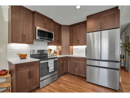 a kitchen with stainless steel appliances a refrigerator sink and microwave