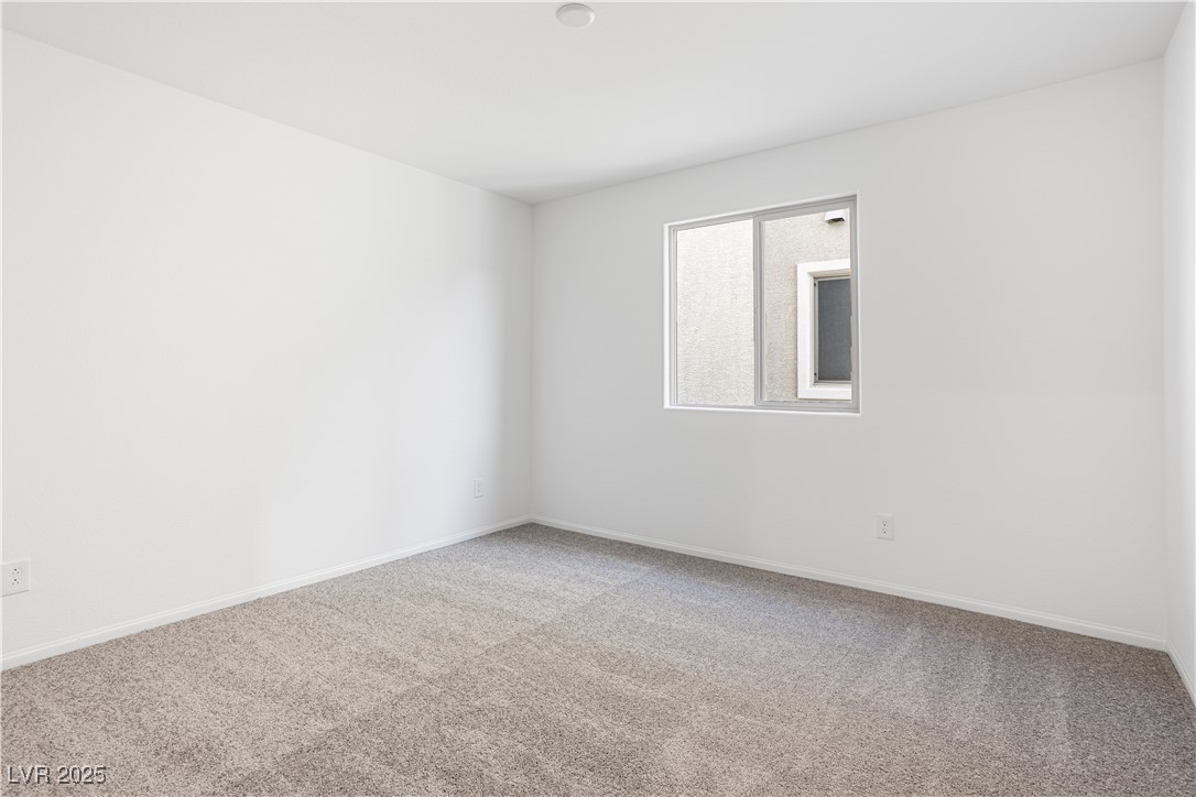 5662 Spring Trellis Street Las Vegas, NV 89113 - Photo 10 of 21 Carpeted spare room featuring baseboards