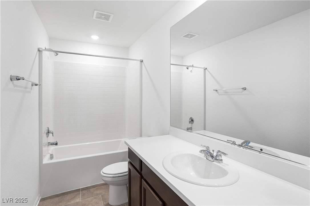5662 Spring Trellis Street Las Vegas, NV 89113 - Photo 13 of 21 Bathroom featuring shower / bath combination, vanity, and light tile patterned floors