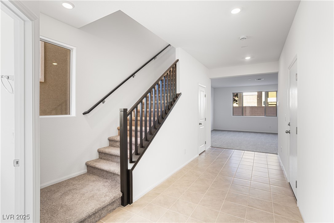 5662 Spring Trellis Street Las Vegas, NV 89113 - Photo 2 of 21 Stairs featuring recessed lighting, carpet flooring, and tile patterned floors