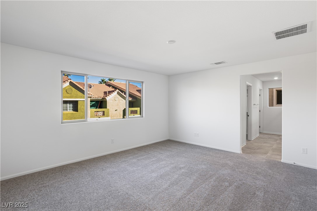 5662 Spring Trellis Street Las Vegas, NV 89113 - Photo 6 of 21 Spare room with light carpet and baseboards