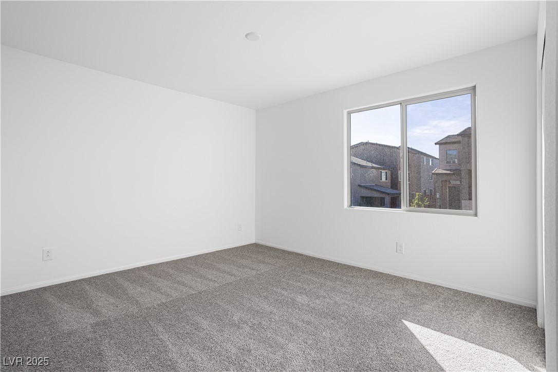 5662 Spring Trellis Street Las Vegas, NV 89113 - Photo 8 of 21 Carpeted empty room featuring baseboards