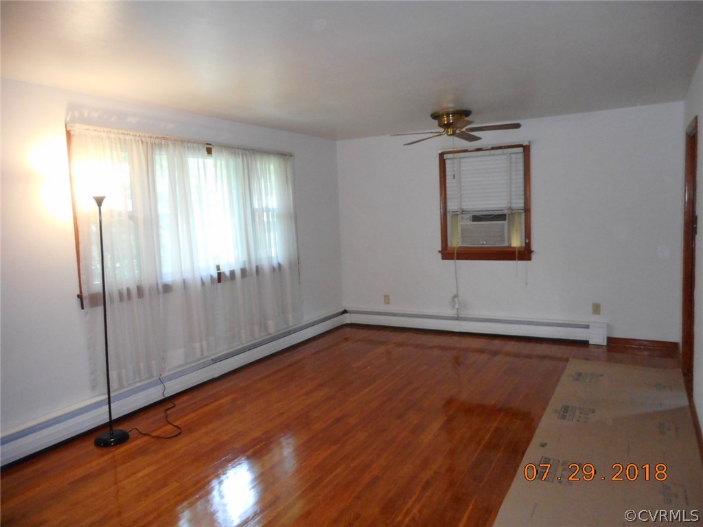 4707 East Caryhurst Road Richmond, VA 23223 - Photo 4 of 11 a view of an empty room with window and wooden floor