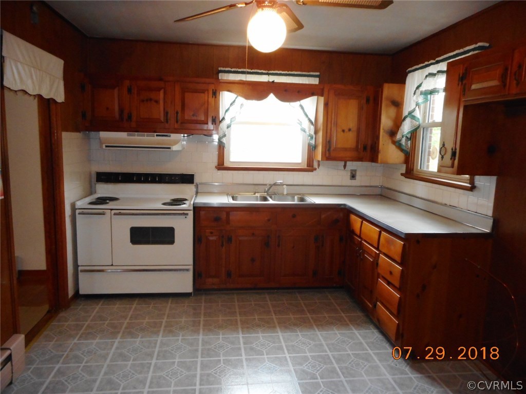 4707 East Caryhurst Road Richmond, VA 23223 - Photo 5 of 11 a kitchen with a sink stove and microwave