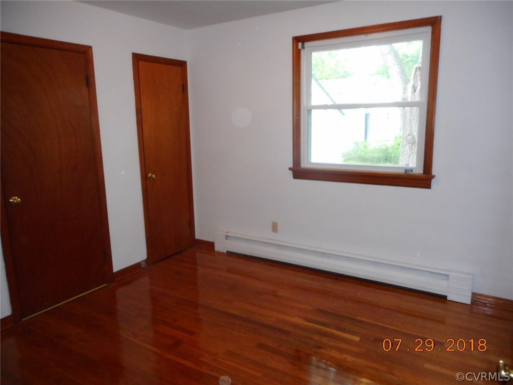 4707 East Caryhurst Road Richmond, VA 23223 - Photo 6 of 11 an empty room with wooden floor and windows