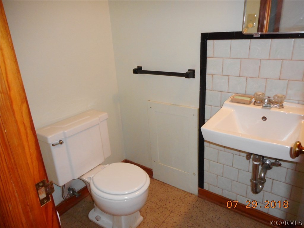 4707 East Caryhurst Road Richmond, VA 23223 - Photo 10 of 11 a white toilet sitting next to a bathroom sink