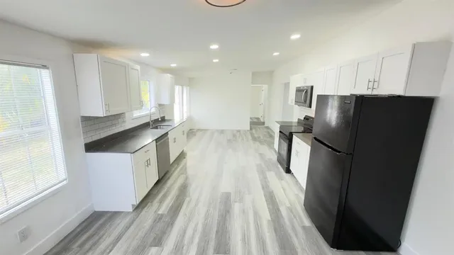 a kitchen with stainless steel appliances a refrigerator and a sink