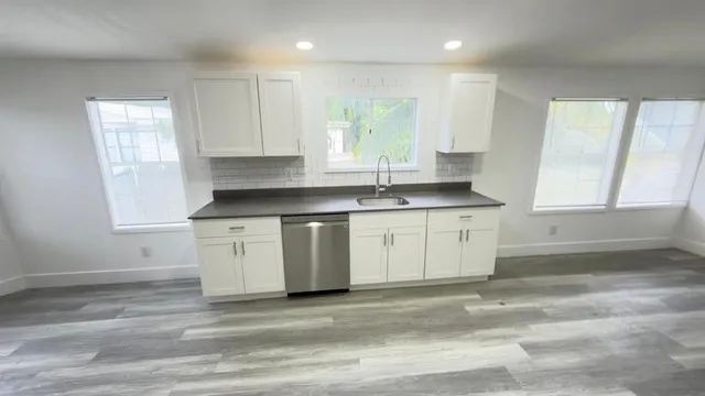 a kitchen with a sink stove and cabinets