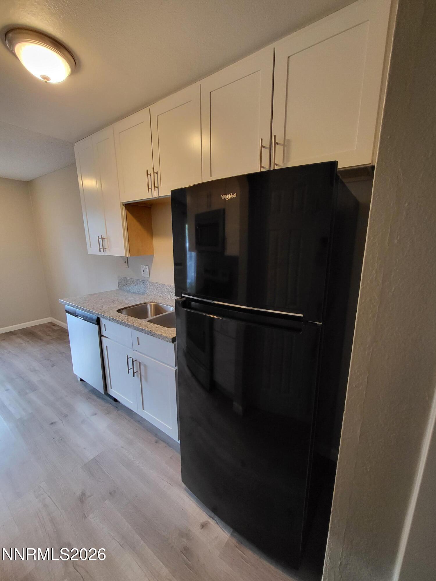 4606 Neil Road, Unit 197 Reno, NV 89502 - Photo 25 of 26 a kitchen with a refrigerator and a stove