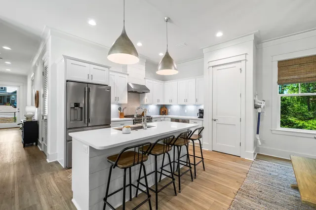 a living room with furniture tv and large window