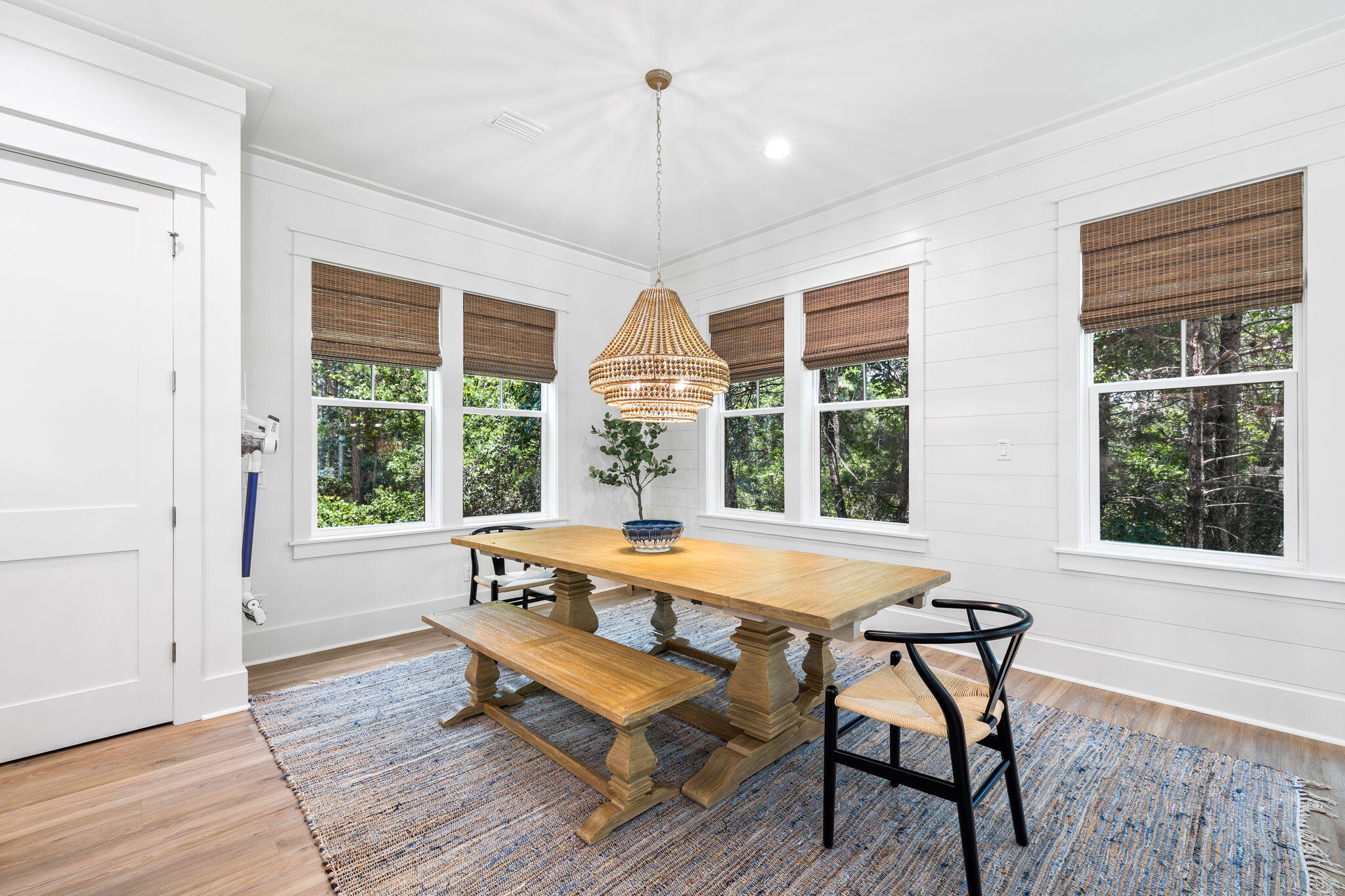 213 Spotted Dolphin Road Santa Rosa Beach, FL 32459 - Photo 25 of 72 a dining room with wooden floor and a chandelier