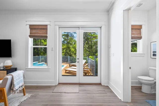 a bathroom with a double vanity sink toilet mirror and bathtub
