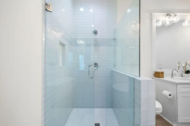 a bathroom with a sink a toilet and shower