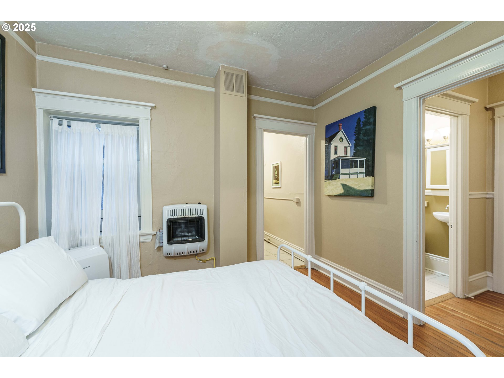 2109 Northwest Irving Street, Unit 114 Portland, OR 97210 - Photo 11 of 29 a bedroom with a bed and a fireplace