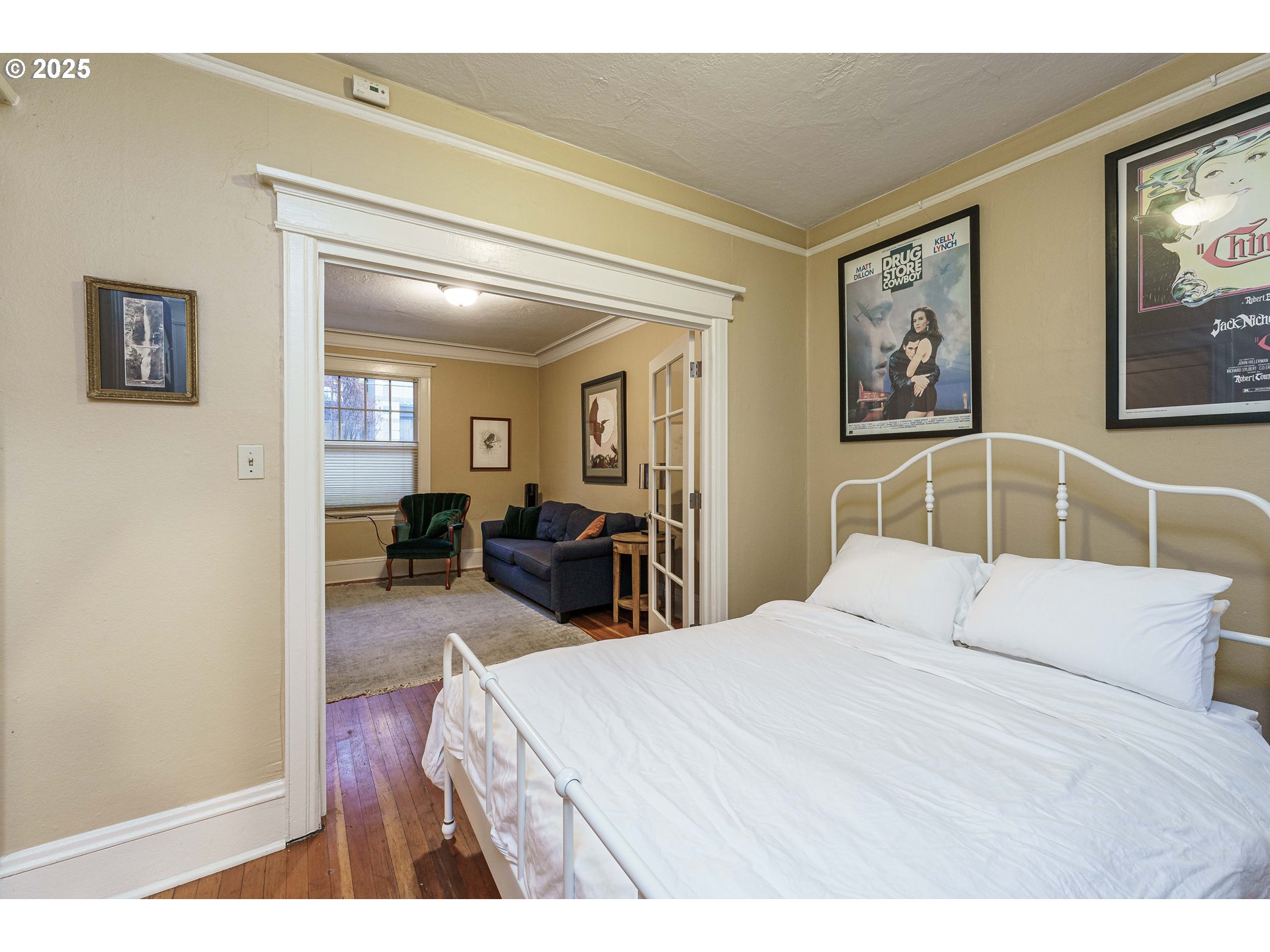 2109 Northwest Irving Street, Unit 114 Portland, OR 97210 - Photo 13 of 29 a bedroom with a bed and a chandelier