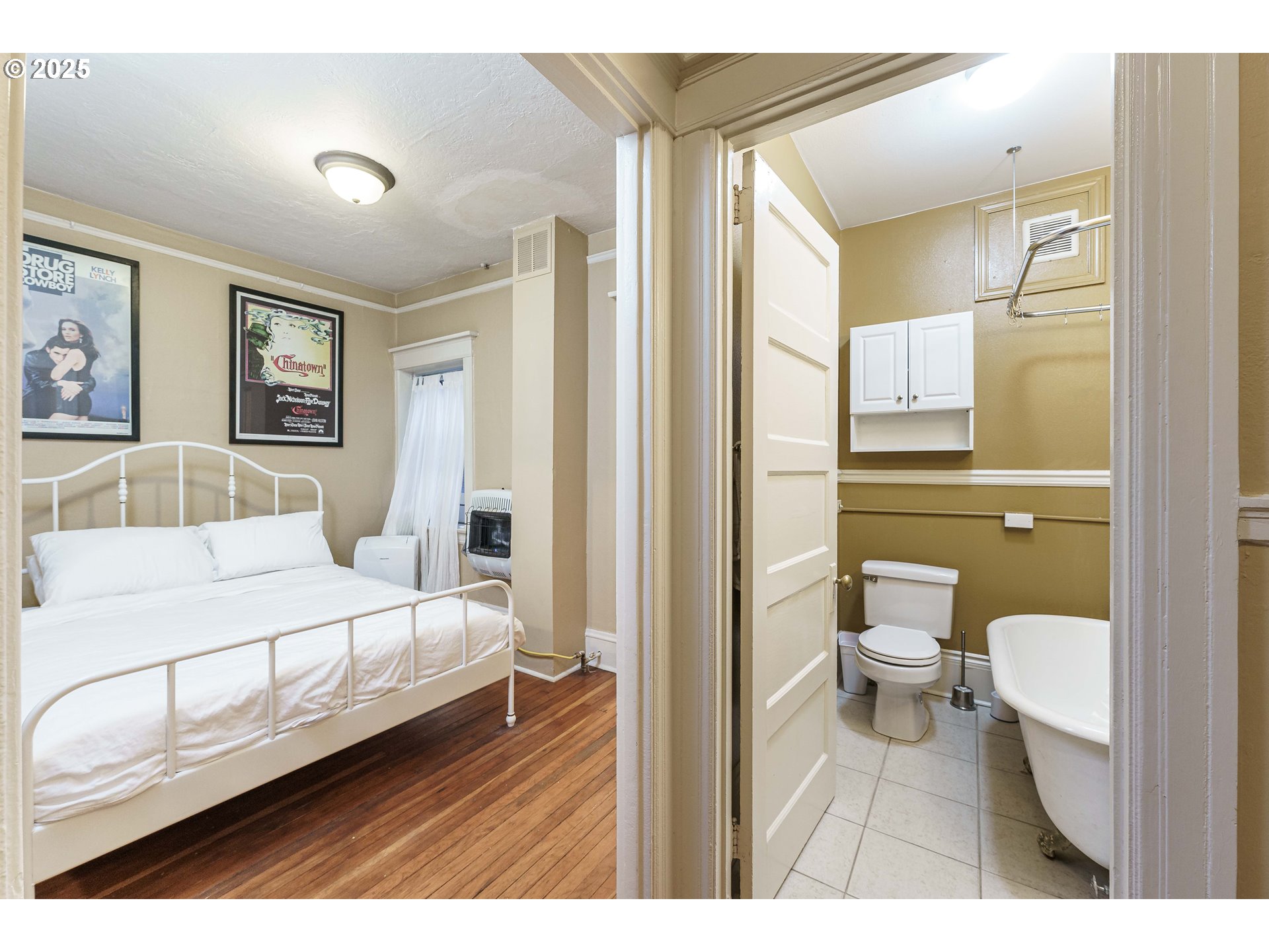 2109 Northwest Irving Street, Unit 114 Portland, OR 97210 - Photo 14 of 29 a bedroom with a bed and a view of bathroom