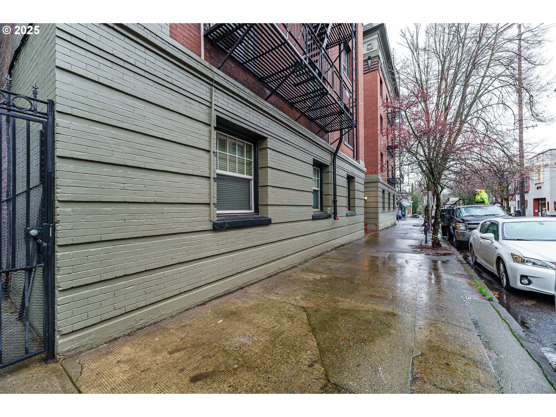 2109 Northwest Irving Street, Unit 114 Portland, OR 97210 - Photo 15 of 29 a view of a parking space with wooden fence