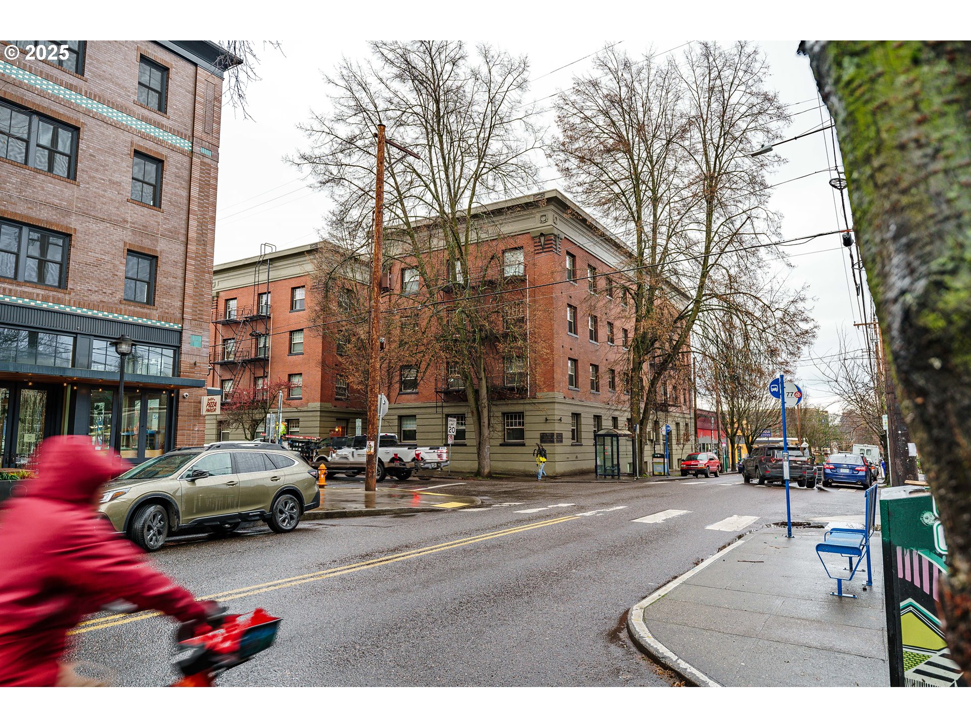2109 Northwest Irving Street, Unit 114 Portland, OR 97210 - Photo 17 of 29 a city street lined with buildings and cars