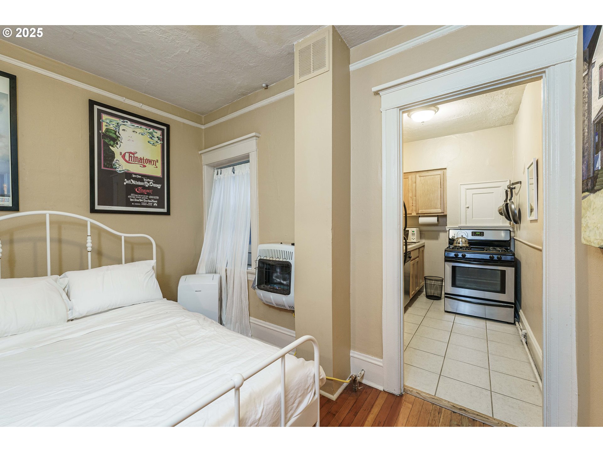 2109 Northwest Irving Street, Unit 114 Portland, OR 97210 - Photo 21 of 29 a bedroom with a bed and a view of bathroom
