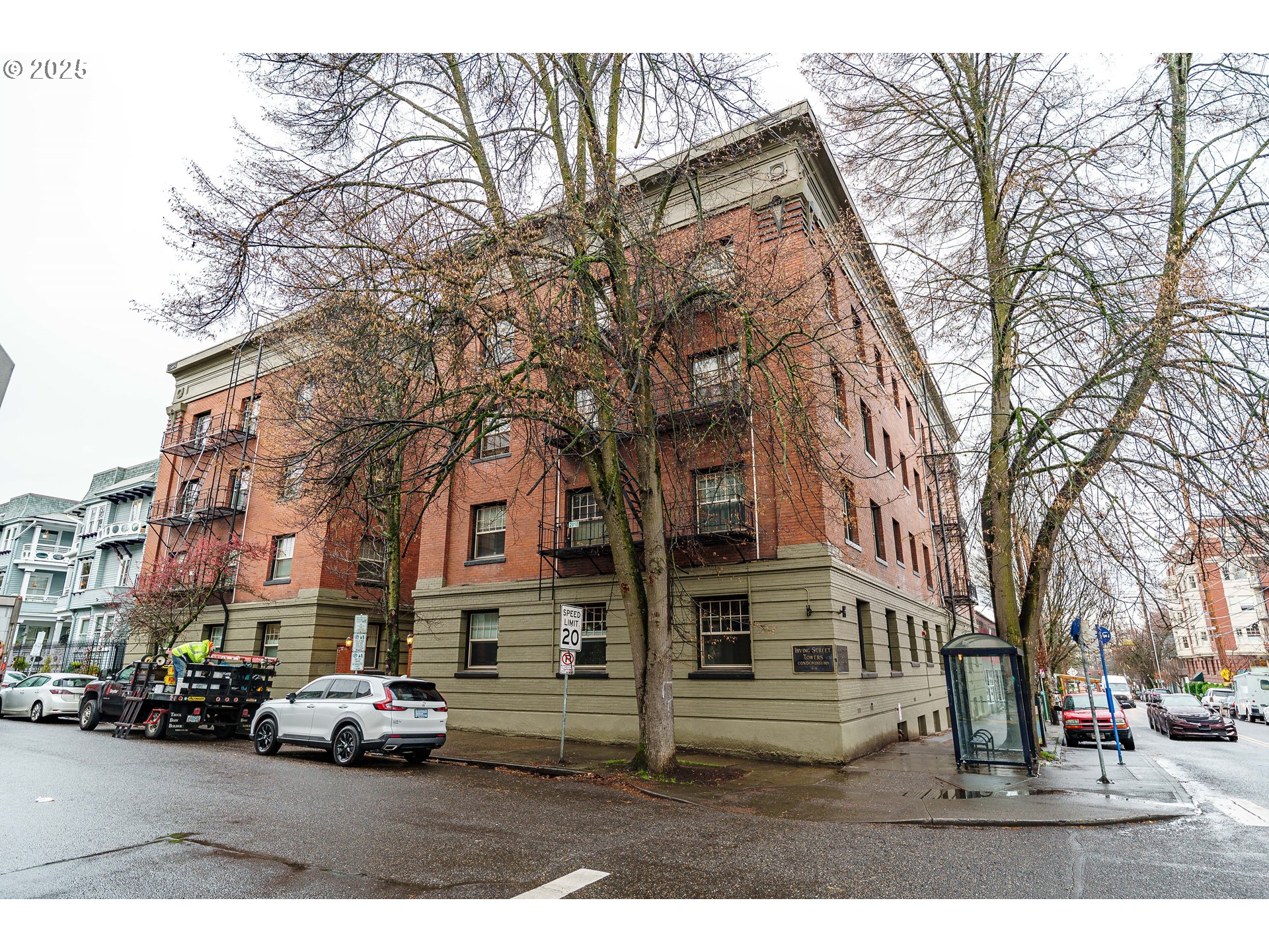 2109 Northwest Irving Street, Unit 114 Portland, OR 97210 - Photo 27 of 29 a city street lined with buildings and cars