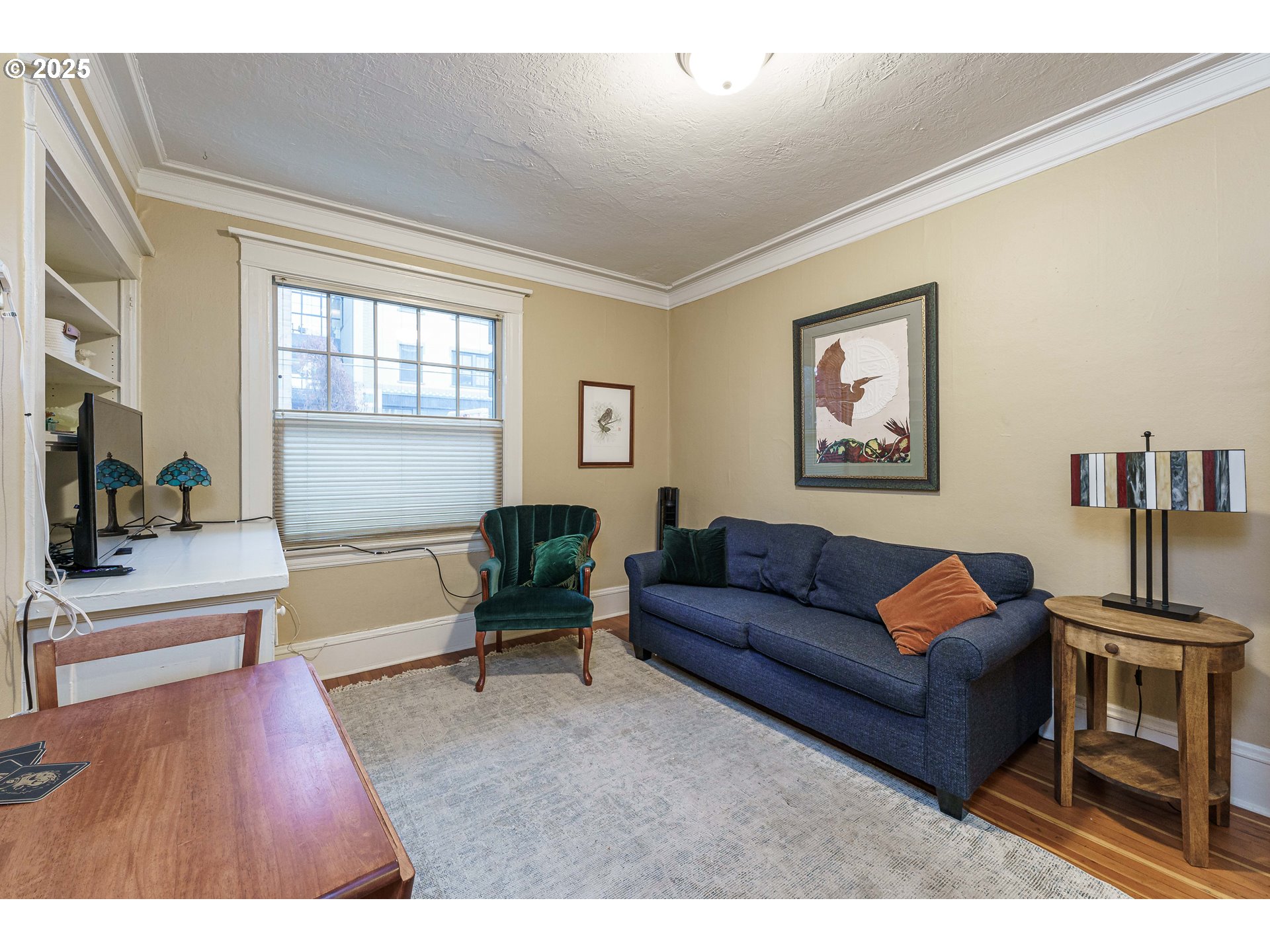 2109 Northwest Irving Street, Unit 114 Portland, OR 97210 - Photo 8 of 29 a living room with furniture and a flat screen tv
