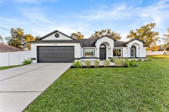 a front view of a house with a yard and garage