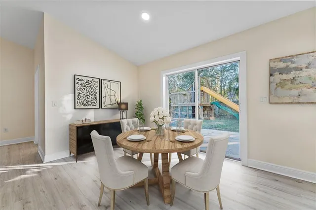 a view of a dining room with furniture window and wooden floor