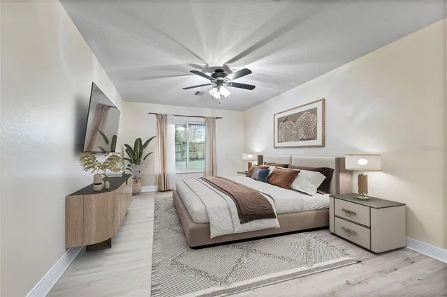 a spacious bedroom with a bed and a chandelier