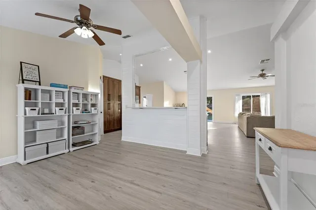a view of a kitchen with furniture and wooden floor