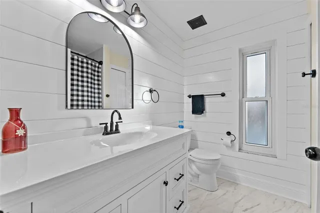 a bathroom with a double vanity sink toilet and shower