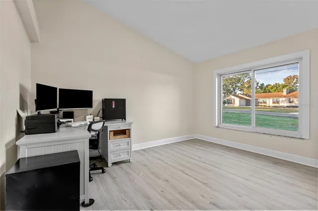 a workspace with furniture hardwood and a window