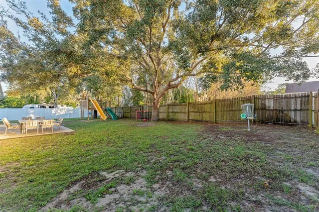a view of a backyard with large trees