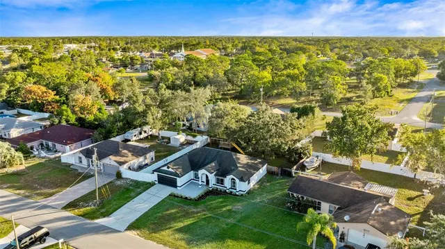 an aerial view of residential houses with outdoor space