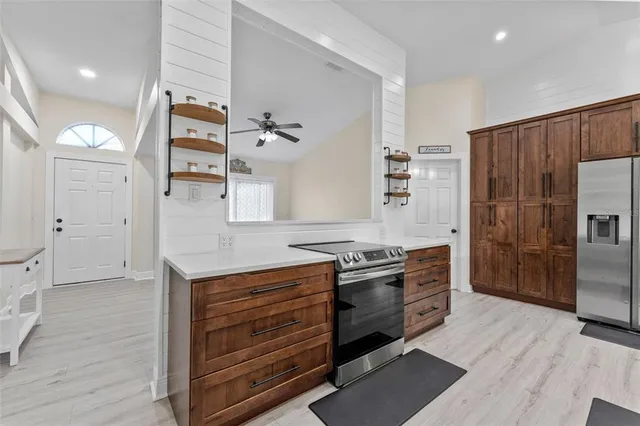 a kitchen with stainless steel appliances granite countertop a stove and a refrigerator