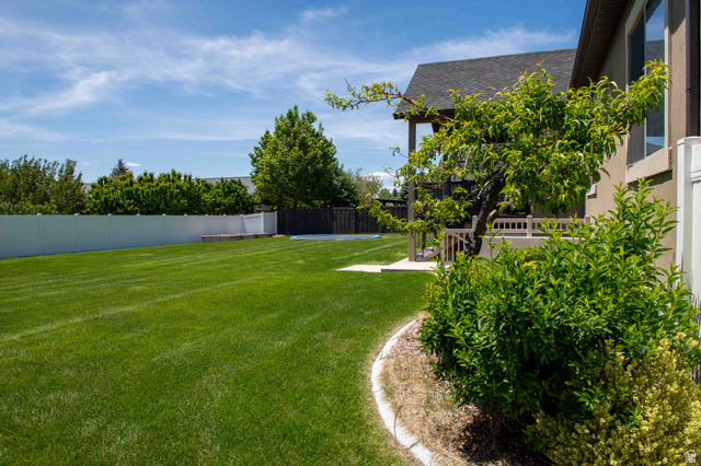 646 East 1400th Street North Mapleton, UT 84664 - Photo 73 of 78 Expansive backyard featuring a lush lawn, mature landscaping, and a white privacy fence