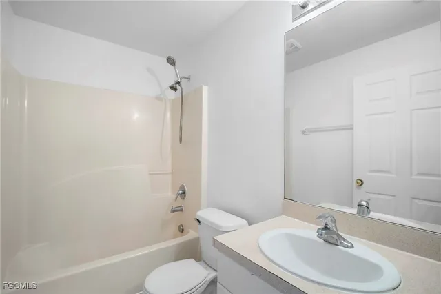 a view of a small space with wooden floor and a window