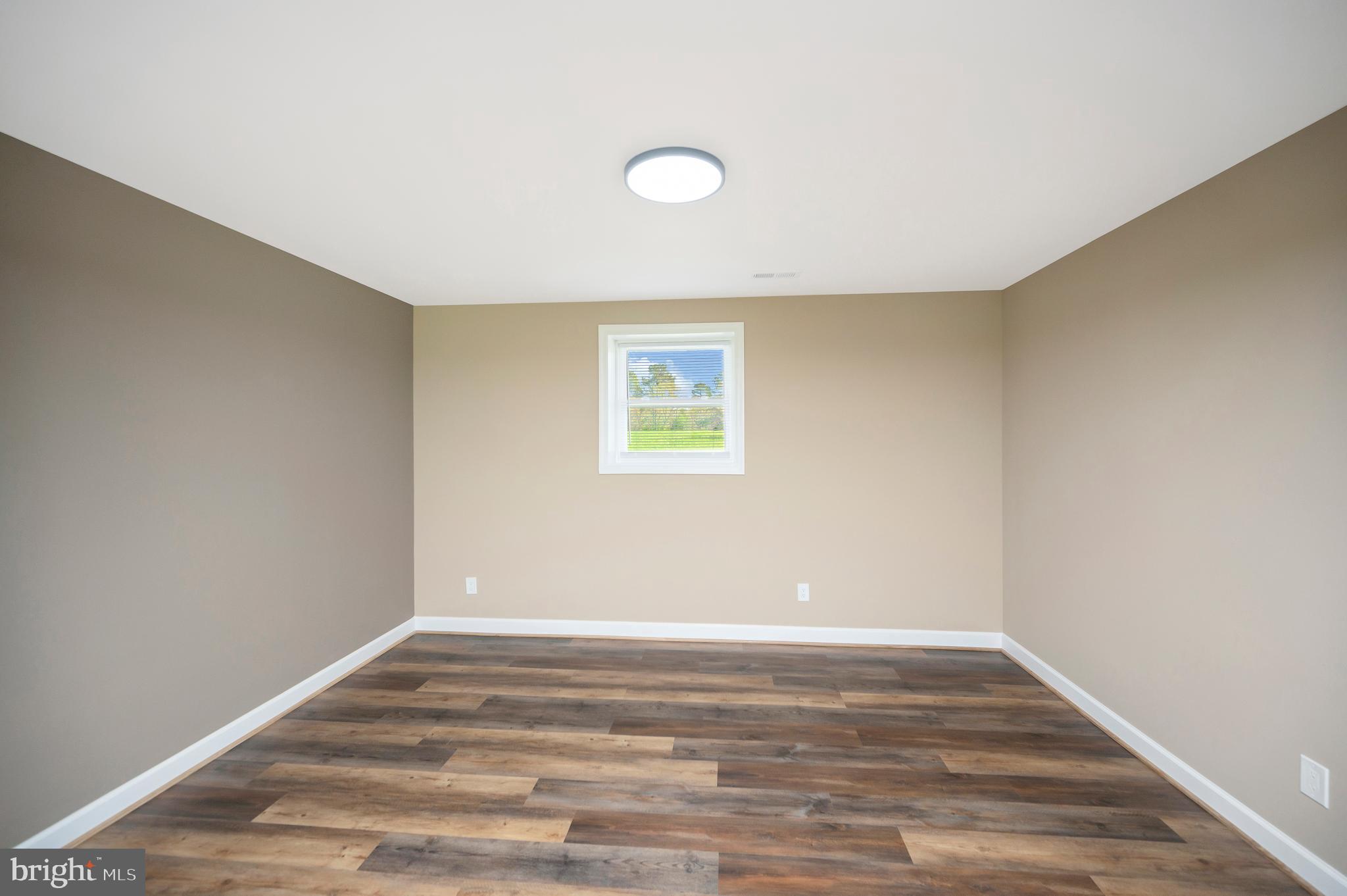 13452 Post Oak Road Spotsylvania, VA 22551 - Photo 42 of 56 a view of a room with wooden floor and white walls
